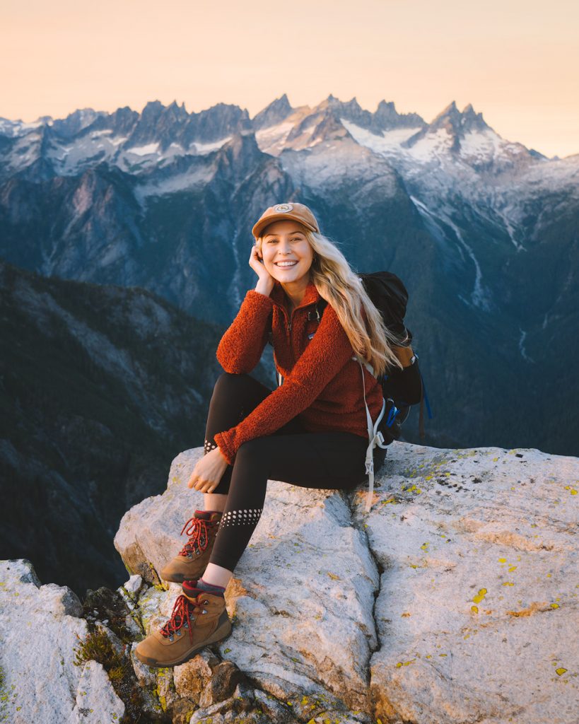 Woman Wearing A Hat And Sports Clothes Relaxing During A Mountain